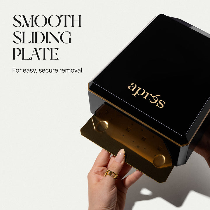 Removable gold-coloured metal base plate sliding out of the Aprés Mini Nova black LED lamp