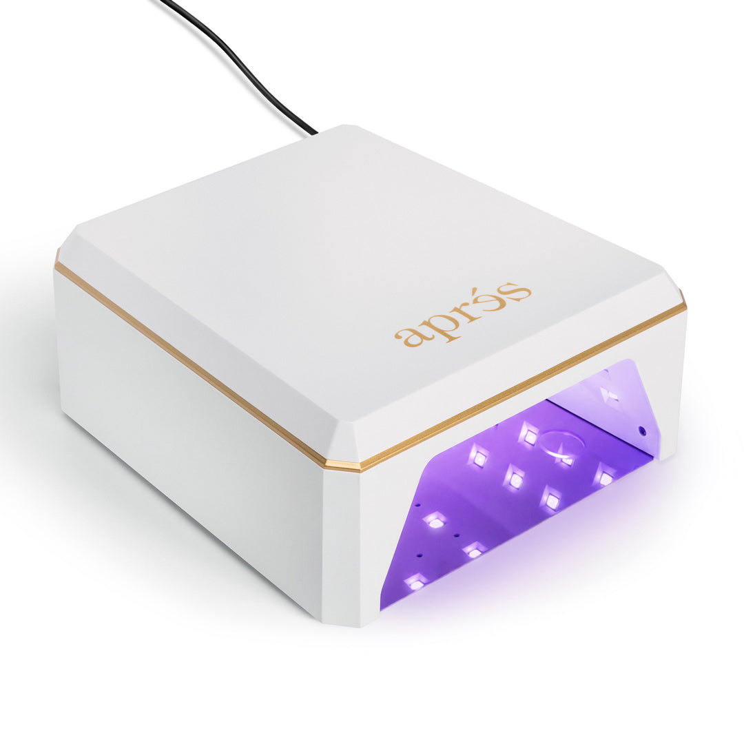 Aprés Mini Nova LED nail lamp in white, front view with the LEDs lit