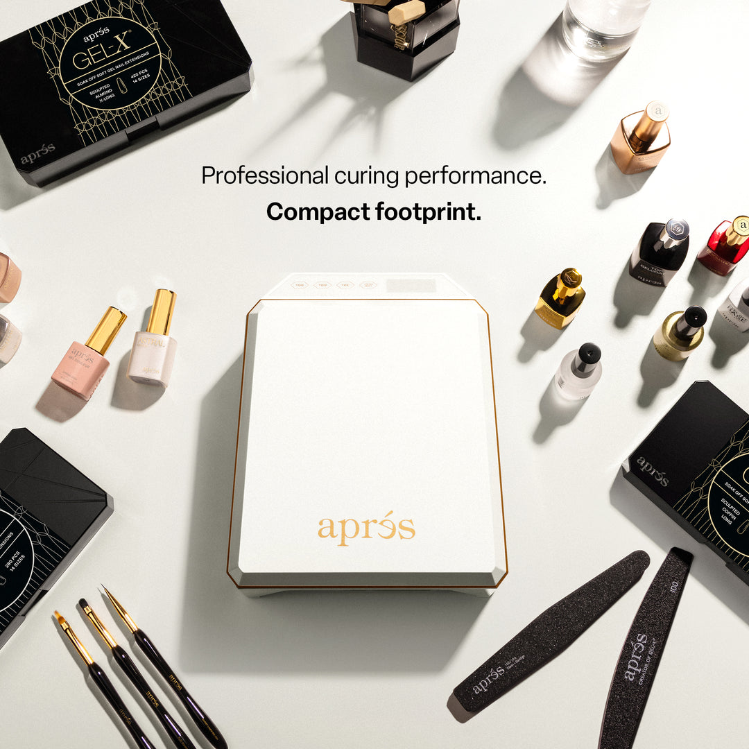 Aprés Mini Nova LED lamp in white seen from above on a nail desk, showing its compact footprint