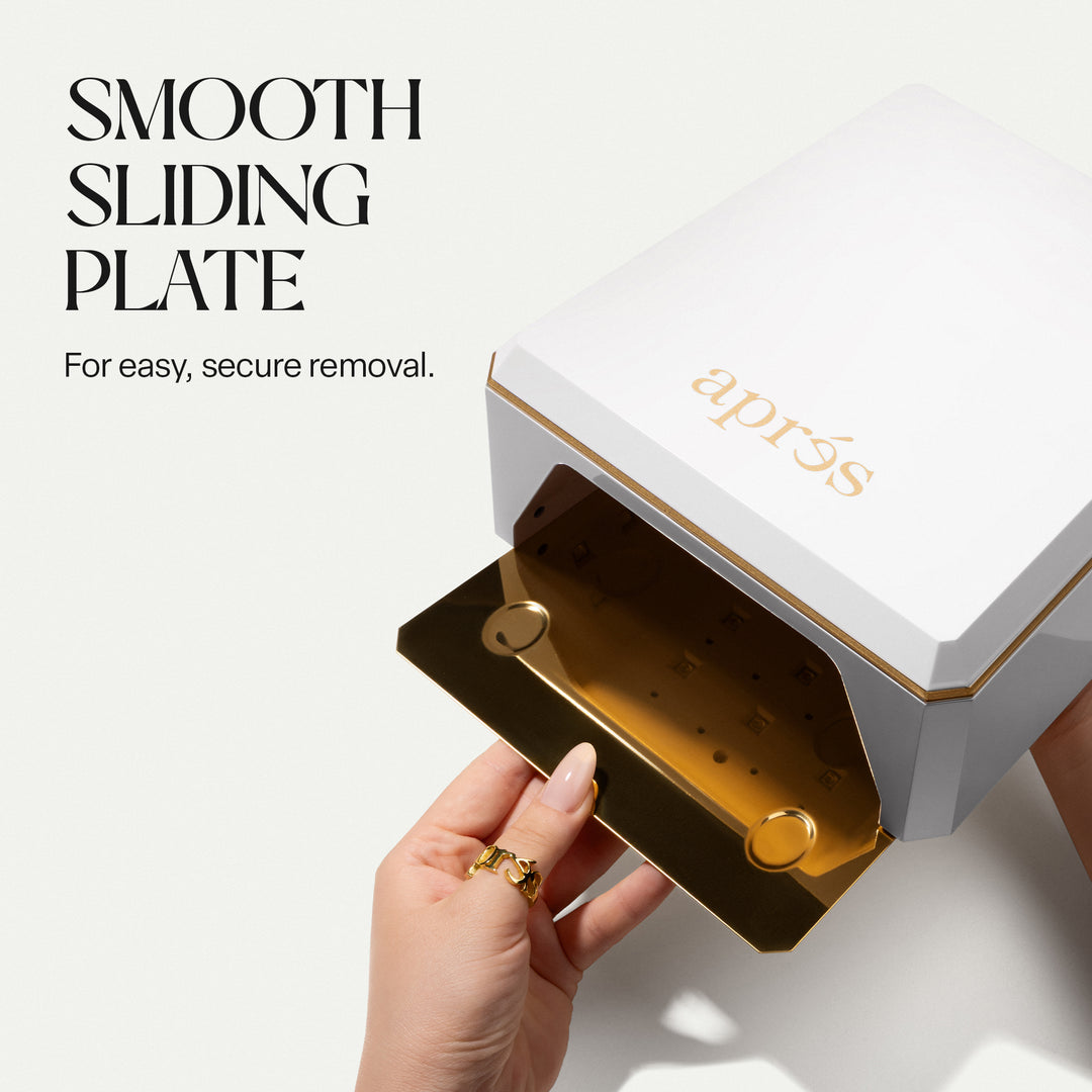 Removable gold-coloured metal base plate sliding out of the Aprés Mini Nova white LED lamp