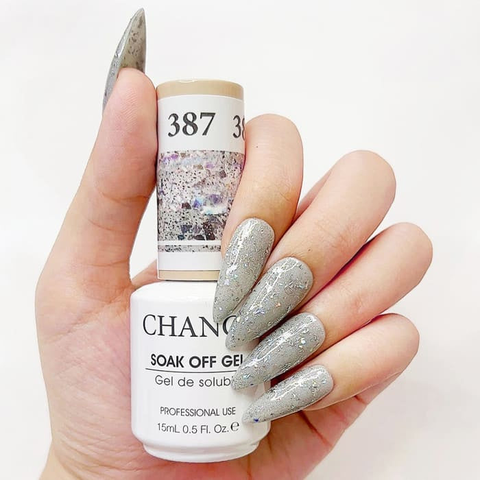 Chance Diamond Dust 387 soak-off gel polish 0.5 oz, bottle held in hand with painted nails