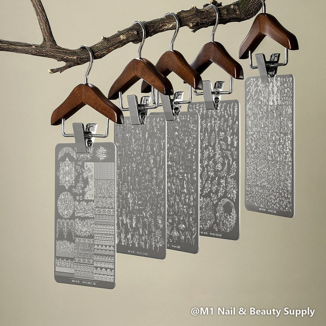 Mr Nail transfer printing steel plates hanging from a branch on wooden hangers, nail stamping plates